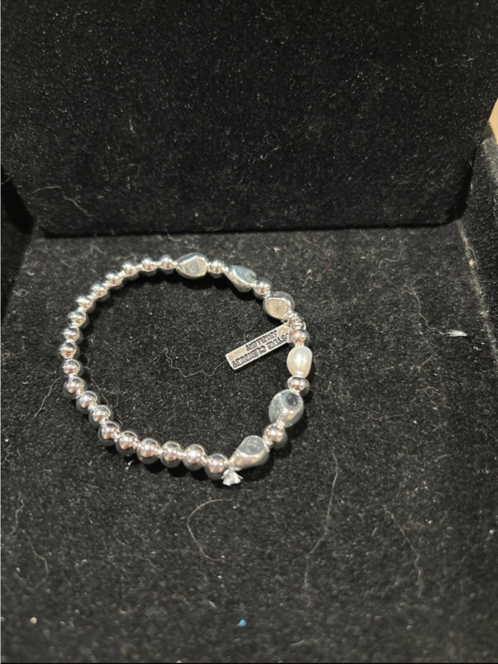 Silver color Beaded Stretch Bracelet has some knot sticking out